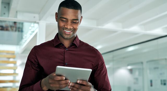 COLOUR-IMAGE_businessman-using-a- tablet_july26