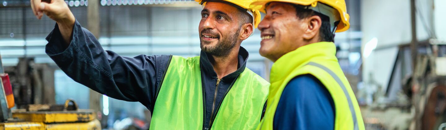 COLOUR-IMAGE_two-men-looking-at-fixture-in-factory_apr26