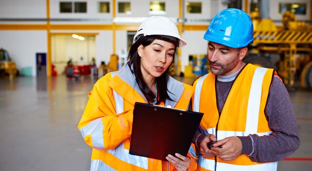 COLOUR-IMAGE_two-colleagues-looking-at-a-clipboard_apr26