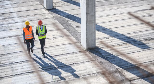 COLOUR-IMAGE_two-contstruction-workers-walking_feb26